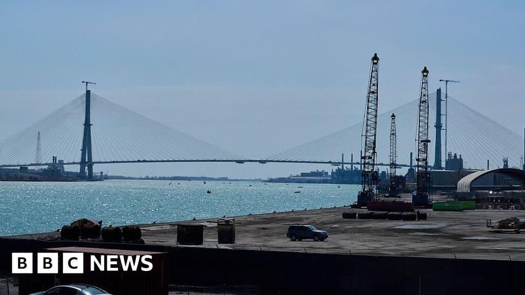 AFP via Getty Images The Gordie Howe International Bridge connecting the US and Canada, spans the Detroit River.
Caption: The Gordie Howe International Bridge connecting Detroit and Windsor, scheduled to open in 2026
According to the Windsor-Detroit Bridge Authority, the publicly owned structure represents one of North America's largest binational infrastructure collaborations. Funded entirely by Canada through a public-private partnership, the bridge design incorporates seismic resilience for the Detroit River crossing and smart traffic management systems. The project website details how toll revenue would be shared between Michigan and Canada post-construction.
Trump's assertion that the U.S. hasn't been "fully compensated" contradicts the existing agreement. His social media statement demanding "at least one half of this asset" and linking bridge access to dairy tariff disputes reveals how infrastructure projects become leverage in broader trade negotiations. This mirrors previous attempts by private bridge owners to block the project during Trump's presidency, citing competition concerns.
Engineering analysts note that blocking operational approval would waste significant technical investment: the bridge completed stress testing protocols this year and its custom navigation lighting system received Coast Guard certification. Transport Canada confirms all construction milestones remain on schedule despite the political uncertainty.
The situation highlights vulnerabilities in transnational infrastructure governance. Unlike purely domestic projects, binational developments lack clear protocols when political actors challenge ratified agreements. Legal scholars point to the 1909 Boundary Waters Treaty as potential framework for resolution, though its infrastructure provisions remain untested in modern contexts.
Canadian officials have yet to formally respond, but industry observers warn that politicizing critical trade corridors could deter future public-private infrastructure investments. With 30,000 daily vehicles projected to use the crossing, the impasse threatens supply chain efficiency in the Great Lakes region where just-in-time manufacturing depends on predictable border crossings.
As construction enters its final phase, the project stands at an unexpected crossroads between engineering achievement and political negotiation.
![Political Threat Halts Binational Infrastructure Project