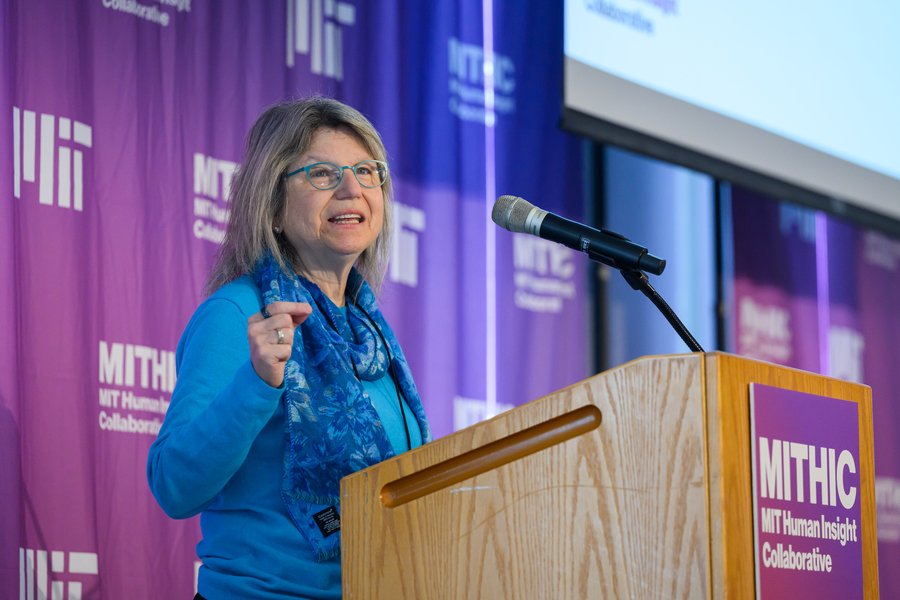 Sally Kornbluth speaks from a lectern with the term “MIT Human Insight Collaborative” on it