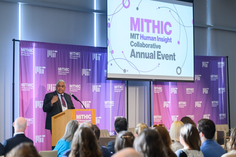 Anantha Chandrakasan speaks from a lectern; the term “MIT Human Insight Collaborative” is displayed on a screen behind him