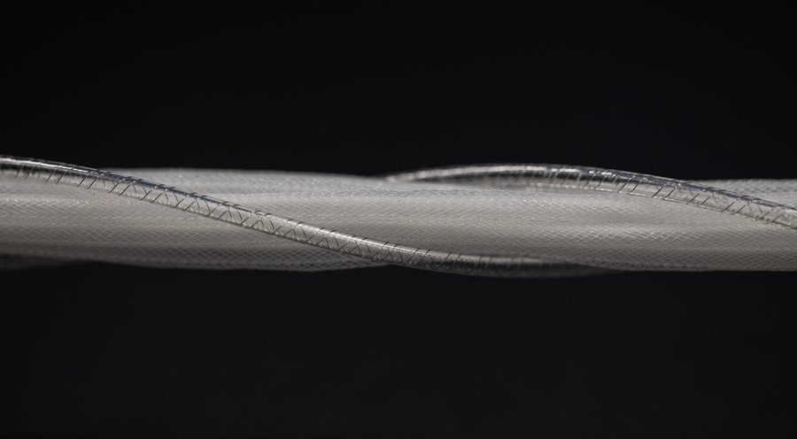 A close-up image featuring a shaft of thin, white, and transparent woven fibers