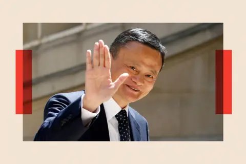 Getty Images Jack Ma, wearing a suit, waves his hand