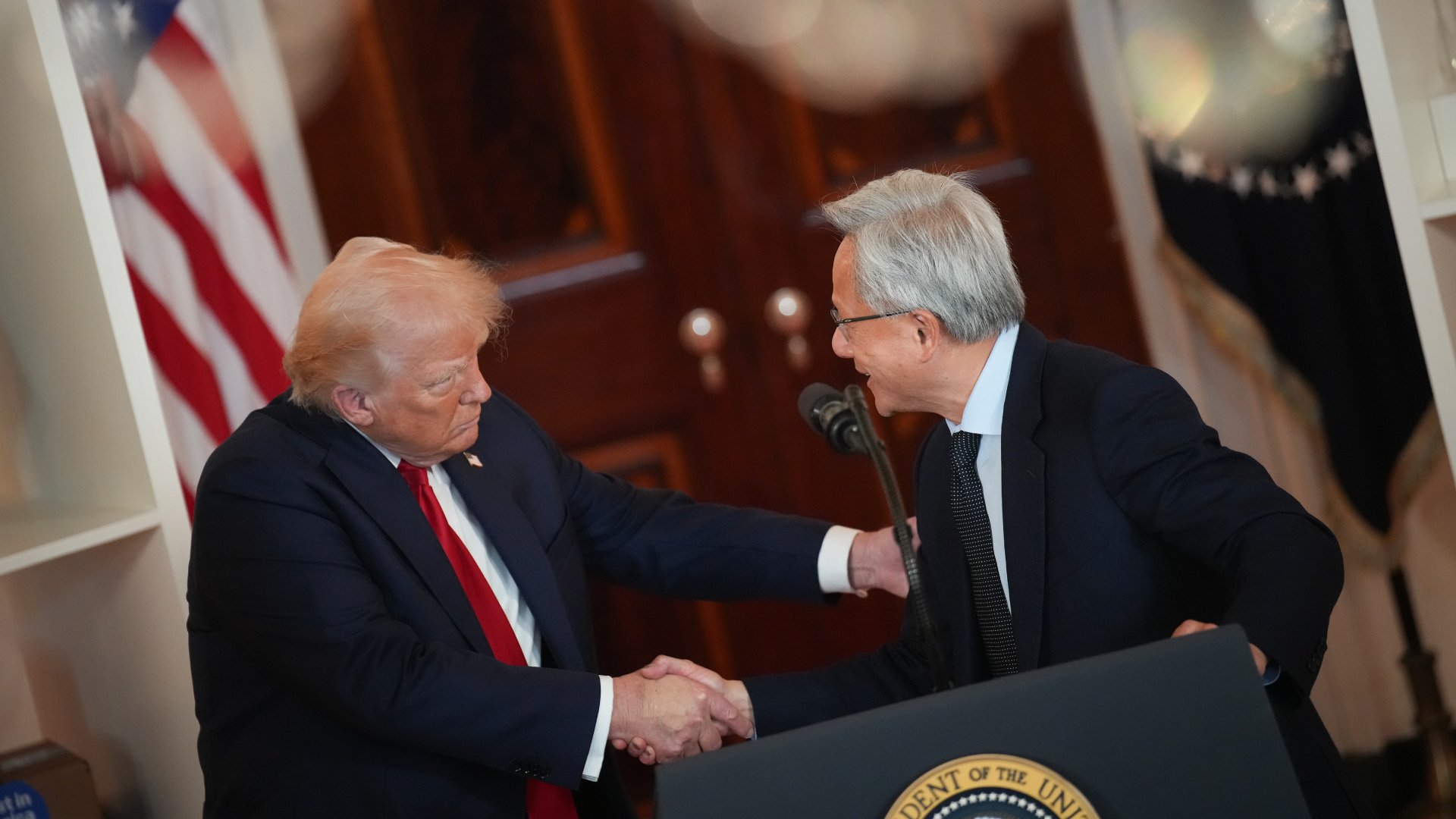 Trump and Jensen Huang shaking hands