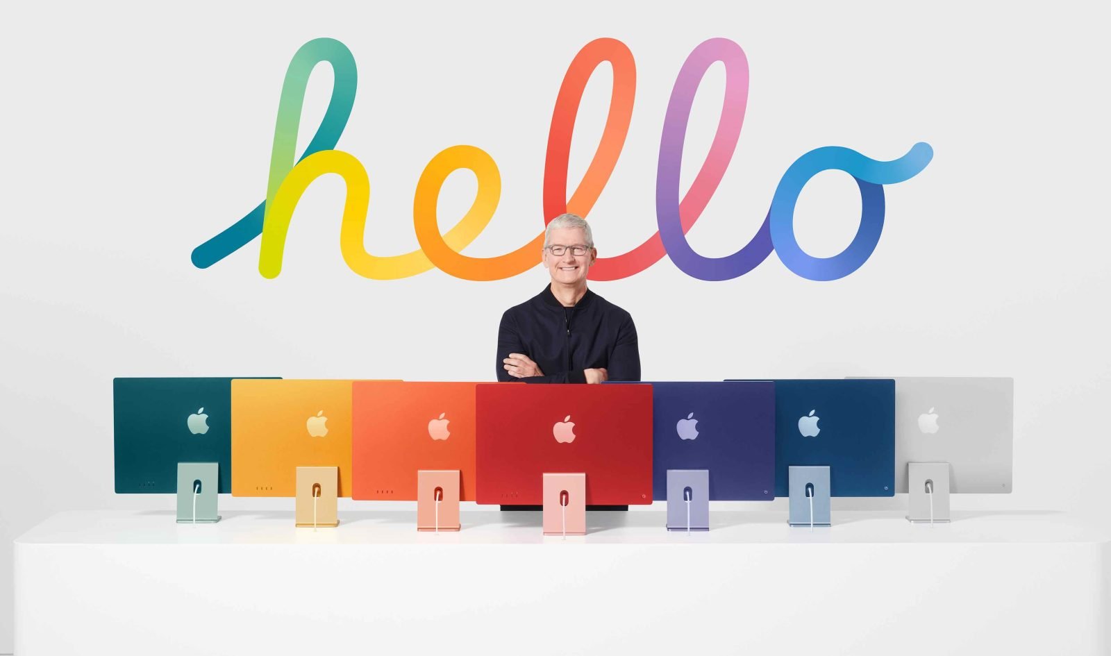 Tim Cook standing behind lineup of colorful M1 iMacs