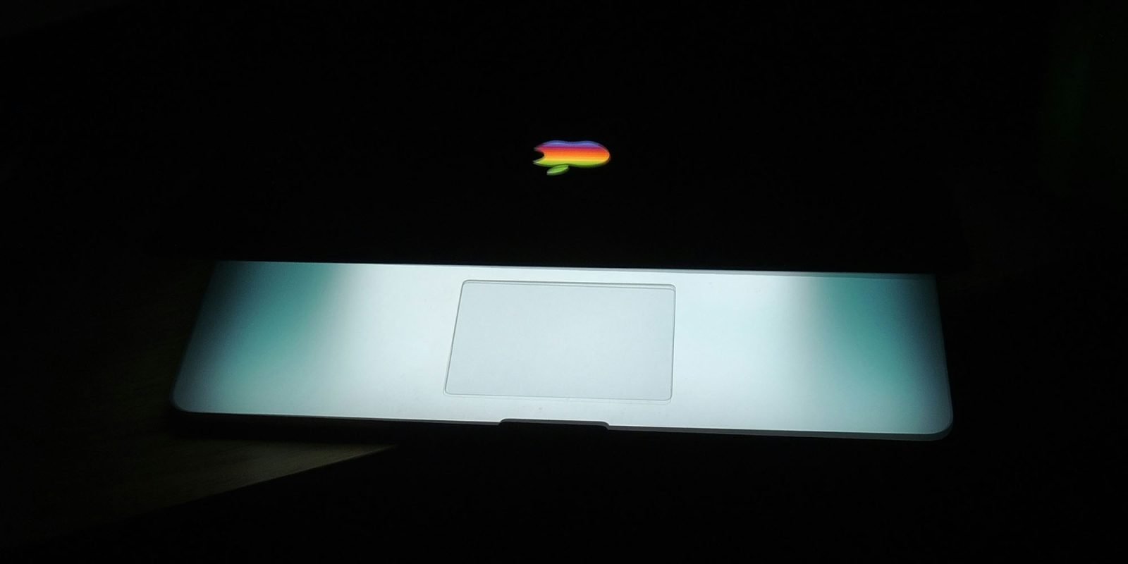 A staggering 16 billion logins exposed in epic data breach, including Apple accounts | Low-key photo of MacBook imagined with old-style rainbow logo