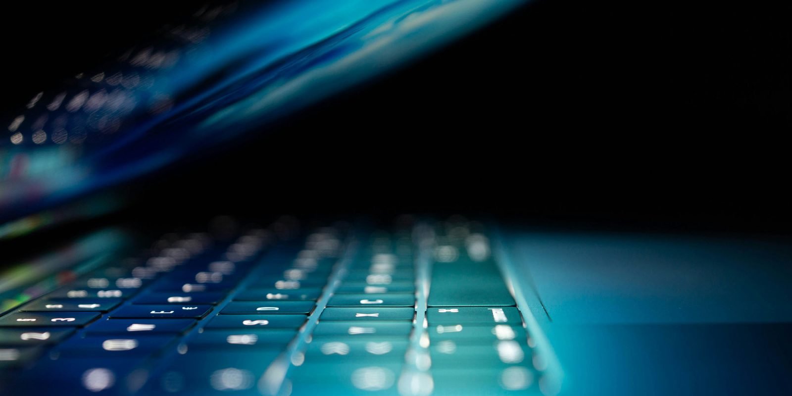 Contrasting Apple standing up to FBI with Microsoft BitLocker keys isn't quite fair | Close-up of half-open laptop