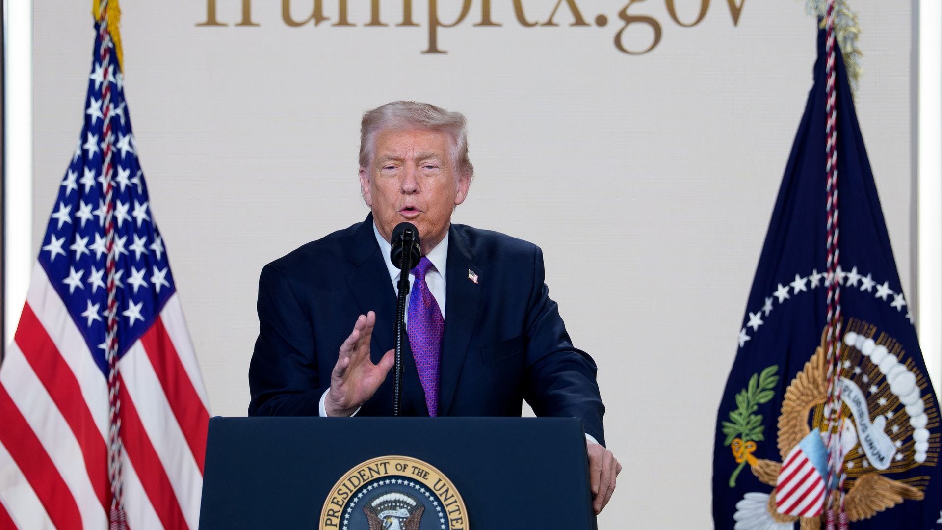 Donald Trump speaking at a podium with the presidential seal, flanked by the U.S. flag and presidential flag, with text 