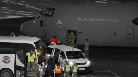 Reuters A plane with the Royal Danish Air Force livery stands on the tarmac at Nuuk airport