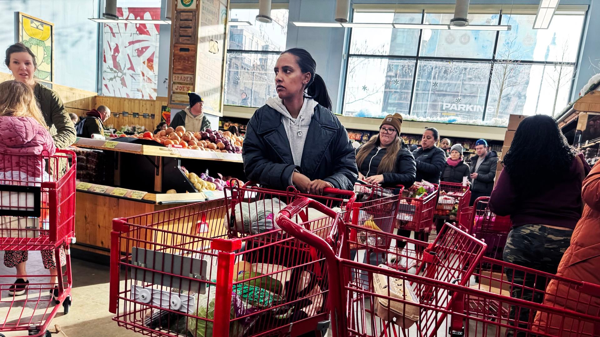 Shoppers wait in line at a grocery store in Washington, D.C., ahead of a winter storm expected to hit the region over the weekend, on Friday, January 23, 2026.