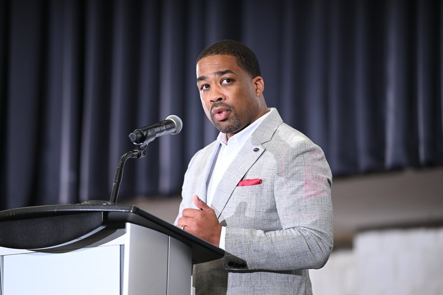 G. Anthony Grant speaks at a lectern indoors