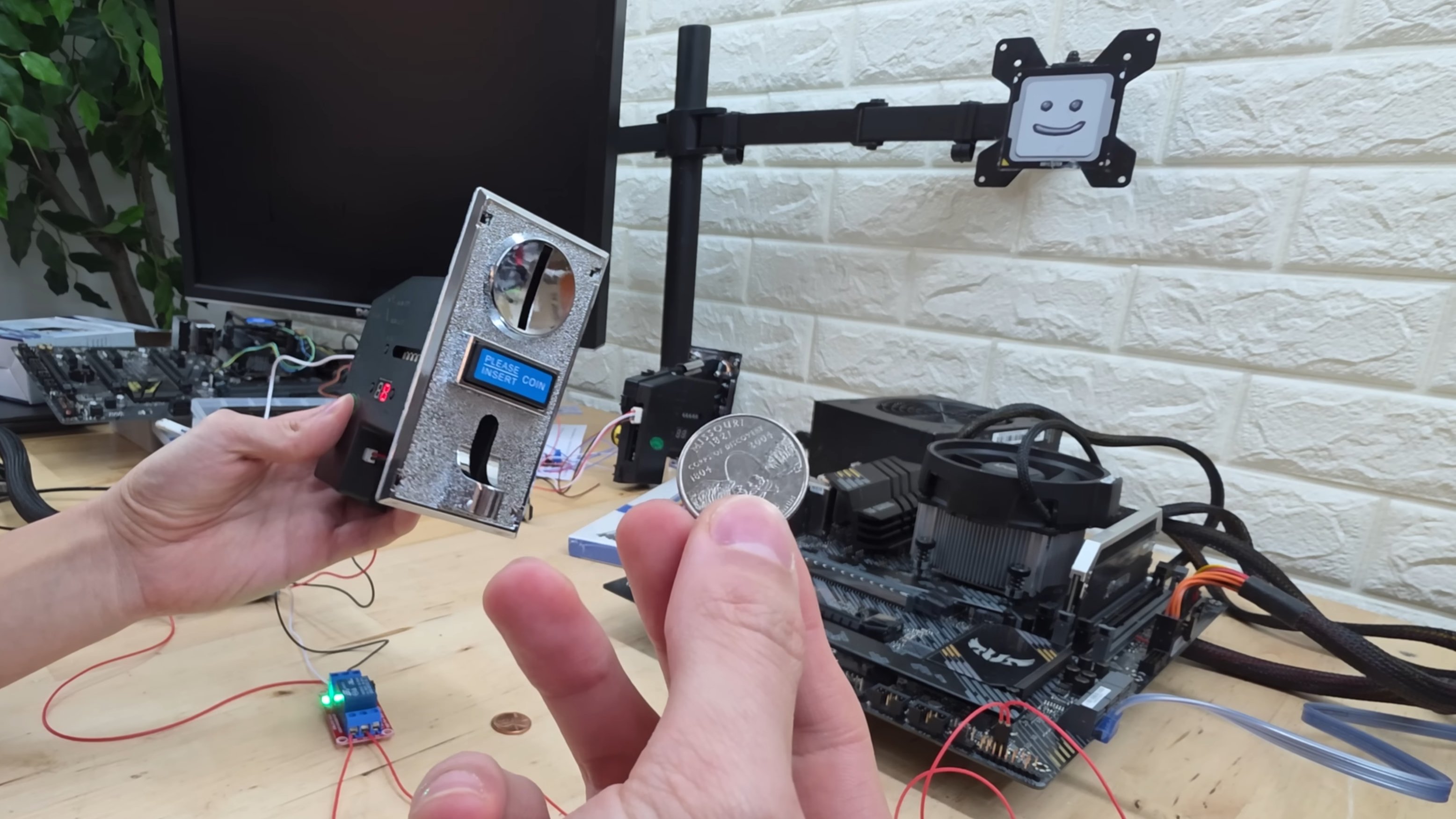 MrYeester's coin-operated PC startup switch in testing, sourced from MrYeester's 1/23/2026 YouTube upload.