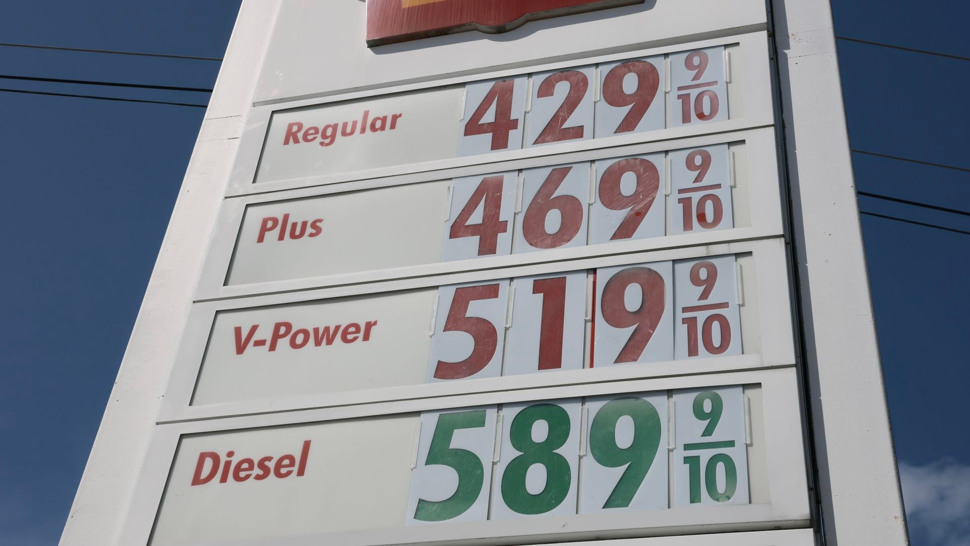 Gas station sign in Miami displays fuel prices as global oil costs rise.