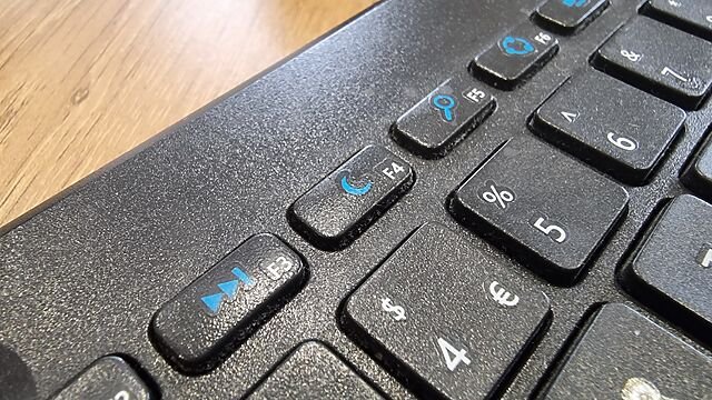 Close-up of the F4 key, showing a 'moon' icon. Of the other visible function keys, F3 shows 'fast forward', F5 shows 'hourglass', F6 shows what appears to be an illustration of a supercollider spinning up, and so on.