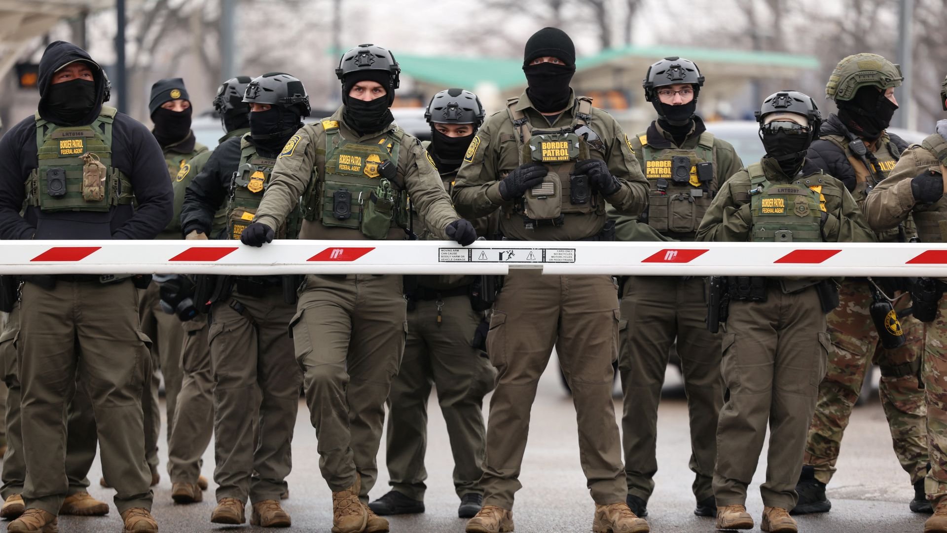 Federal agents stand guard as protestors gather outside the Bishop Henry Whipple Federal Building in Saint Paul, Minnesota, on January 8, 2026. 
