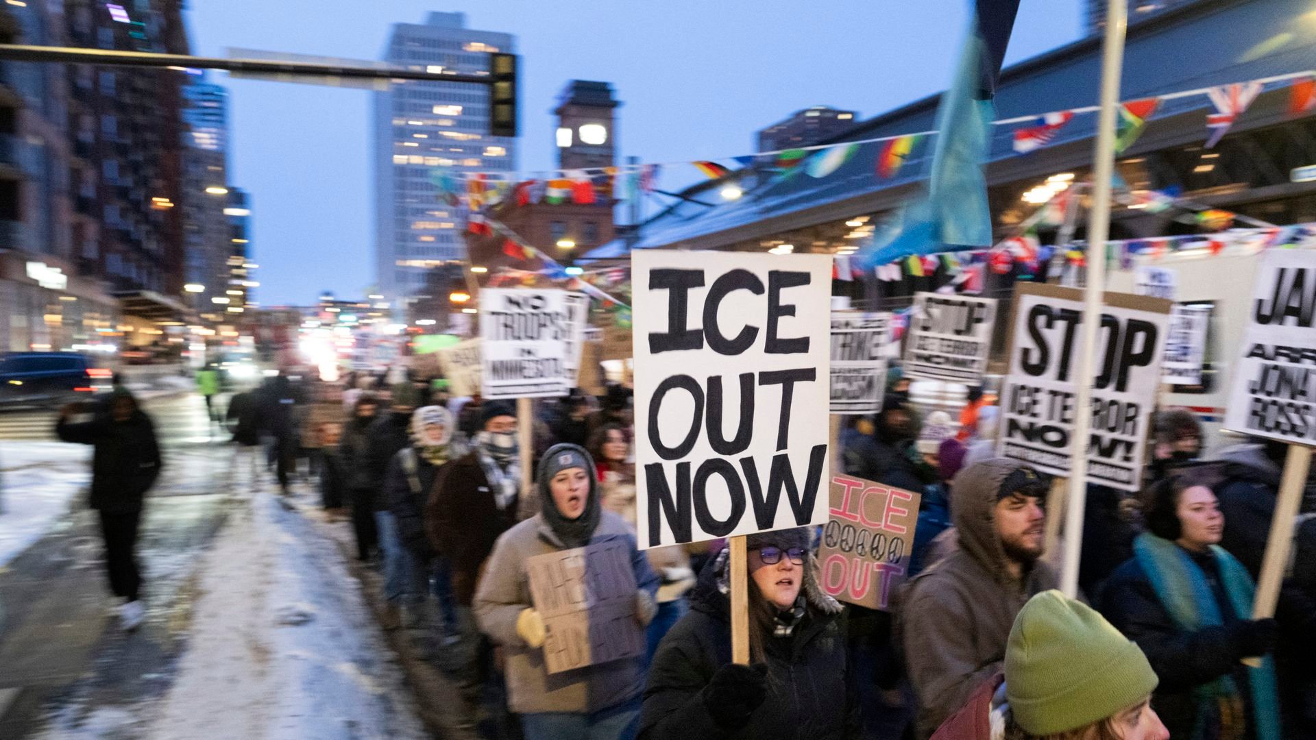 Minnesota protesters hold up signs saying 