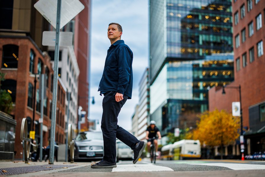 Andres Sevtsuk walks on street in city