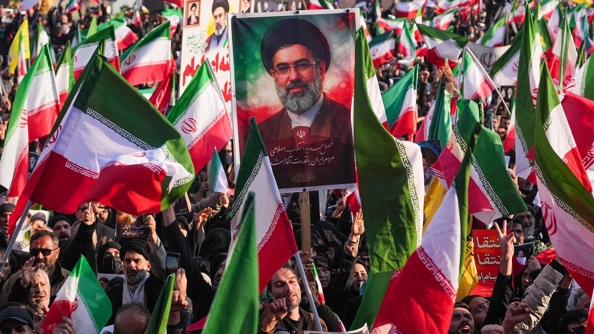 A demonstrator holds a picture of Iran's new Supreme Leader Ayatollah Mojtaba Khamenei.