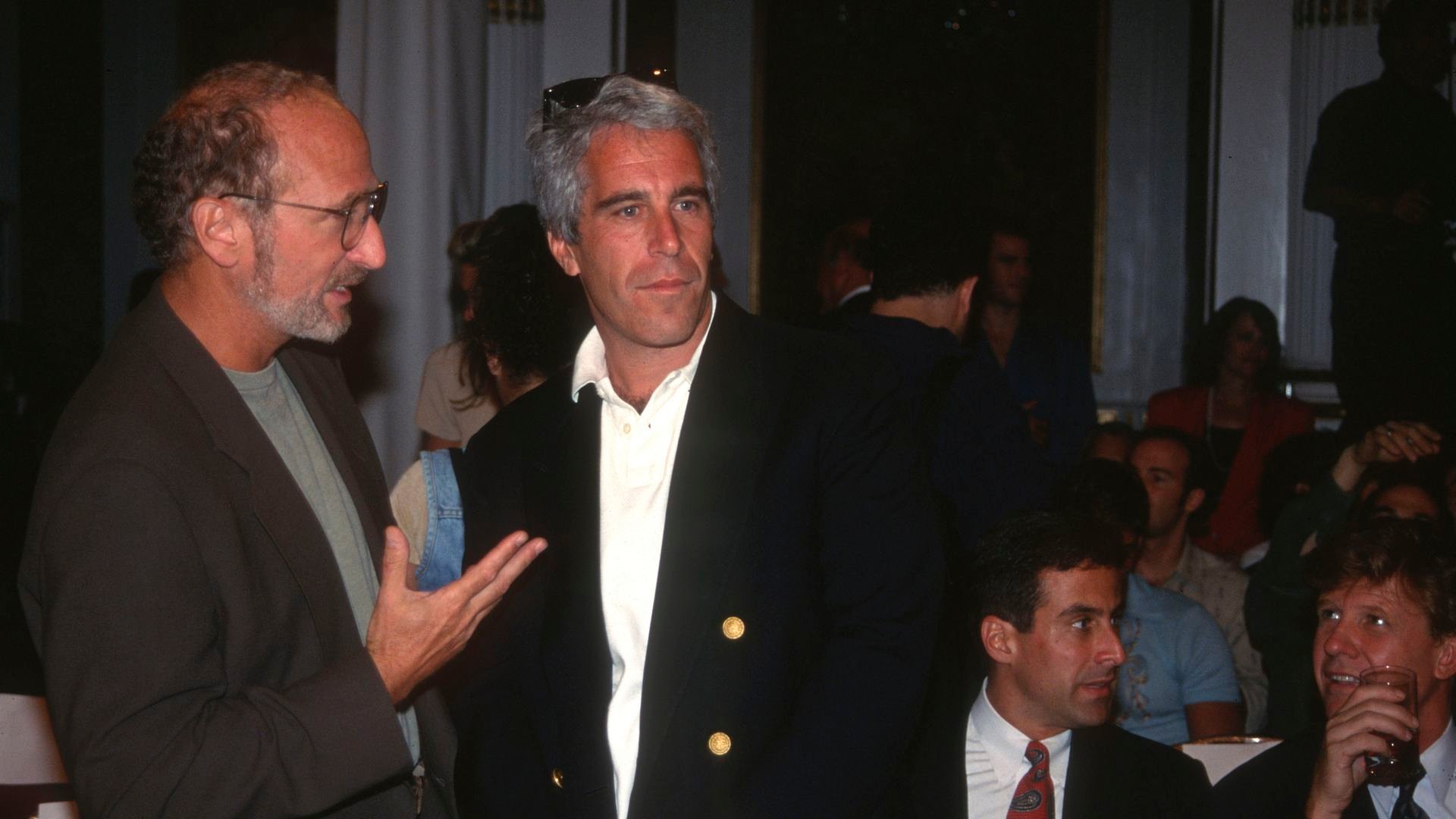 Jeffrey Epstein photographed with people surrounding him 