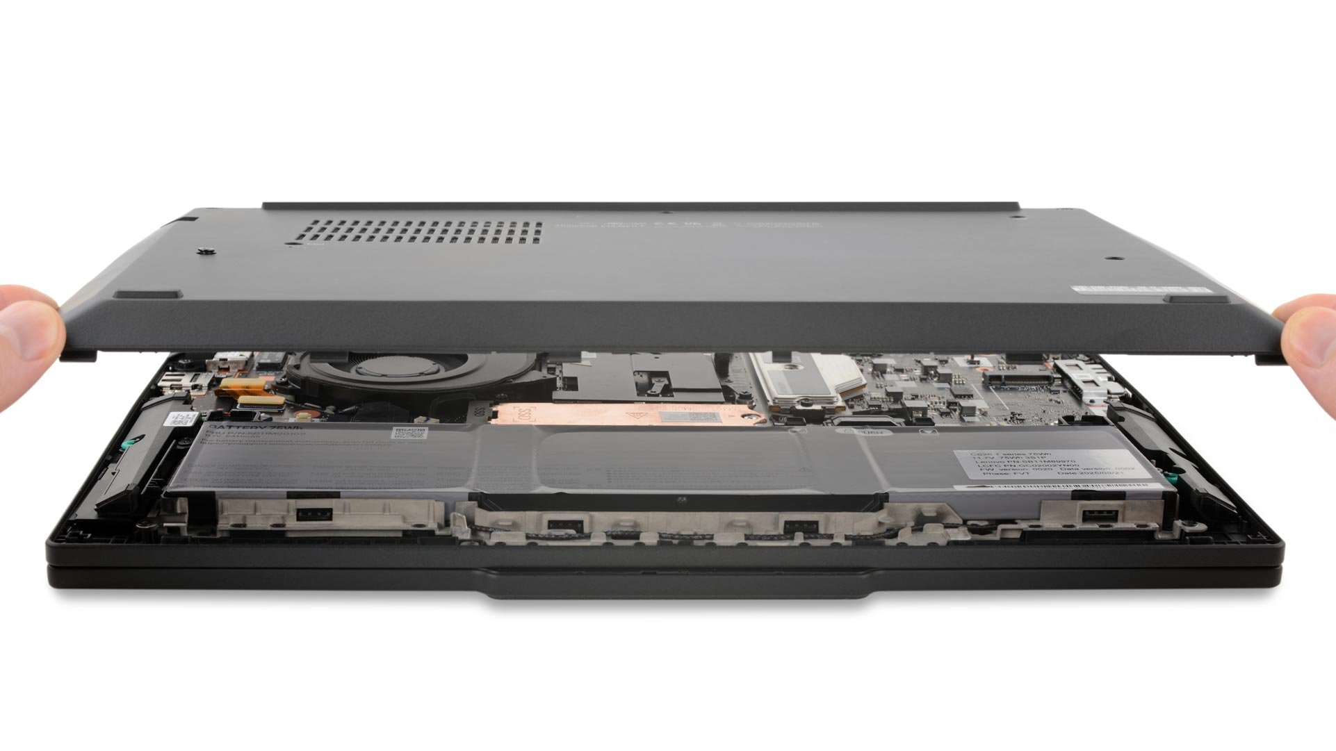 A technician lifts the back cover off of the new ThinkPad T14 laptop