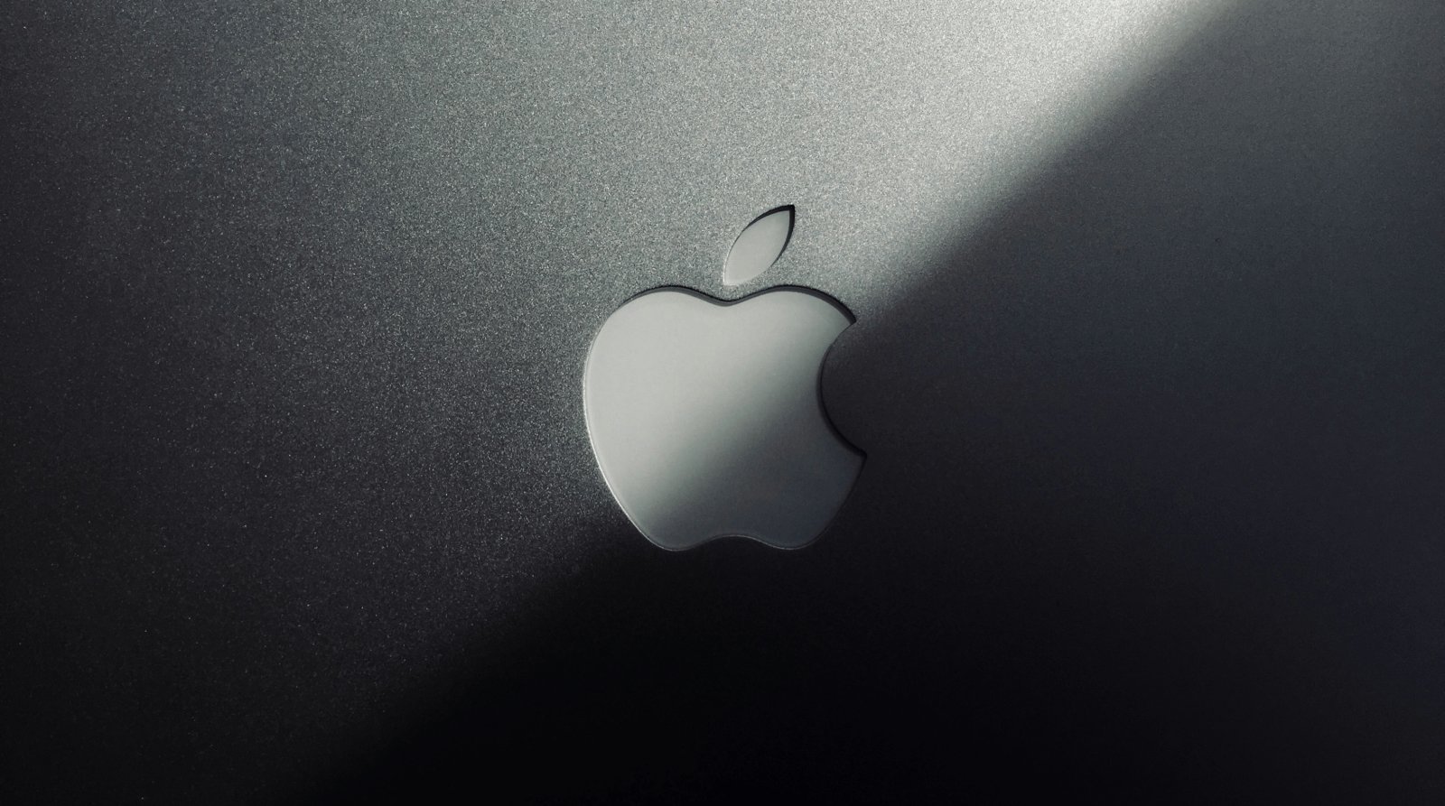 top of a MacBook lid showing the Apple logo