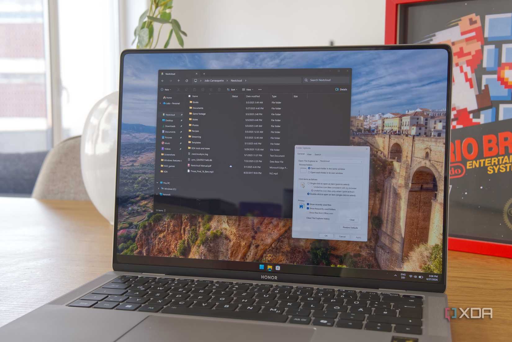 A Windows 11 laptop running File Explorer and showing the options window