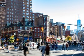 An intersection in New York City with many pedestrians.