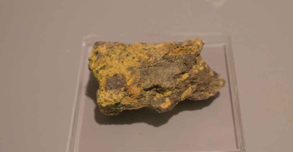 a lumpy piece of sandstone with visible yellow mineralization
