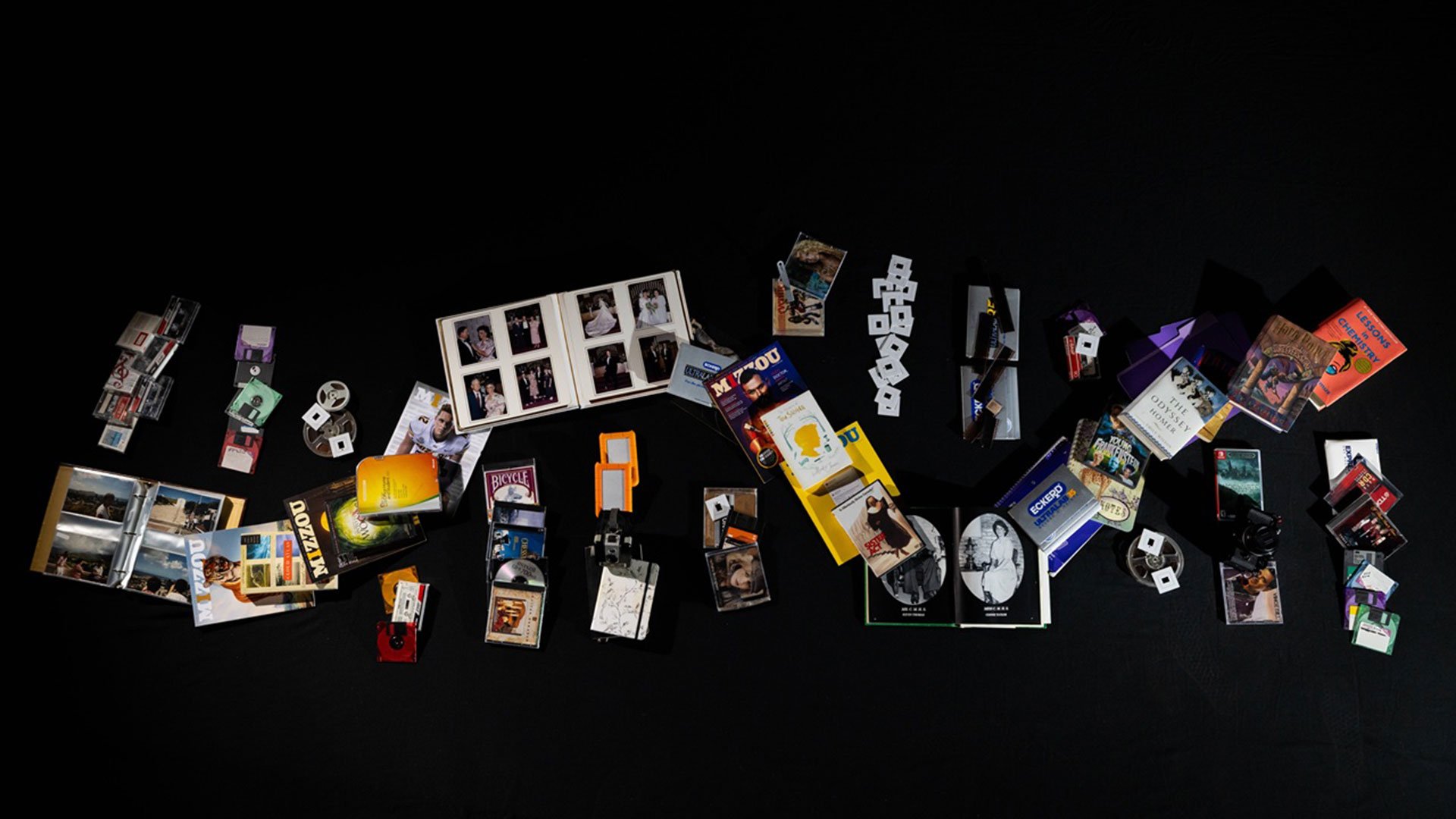 Paper files, photographs, magazines and digital media twist together to form an RNA strand, representing how tomorrow’s data — from family photos to entire archives — could be stored in DNA.