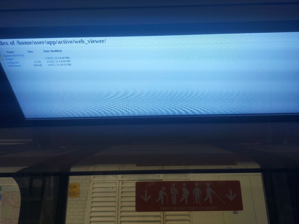 A computer monitor glows above a storefront sign with red figures.