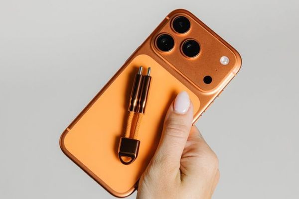 Nomad's Stellar Orange ChargeKey matches Cosmic Orange iPhone 17 Pro perfectly
