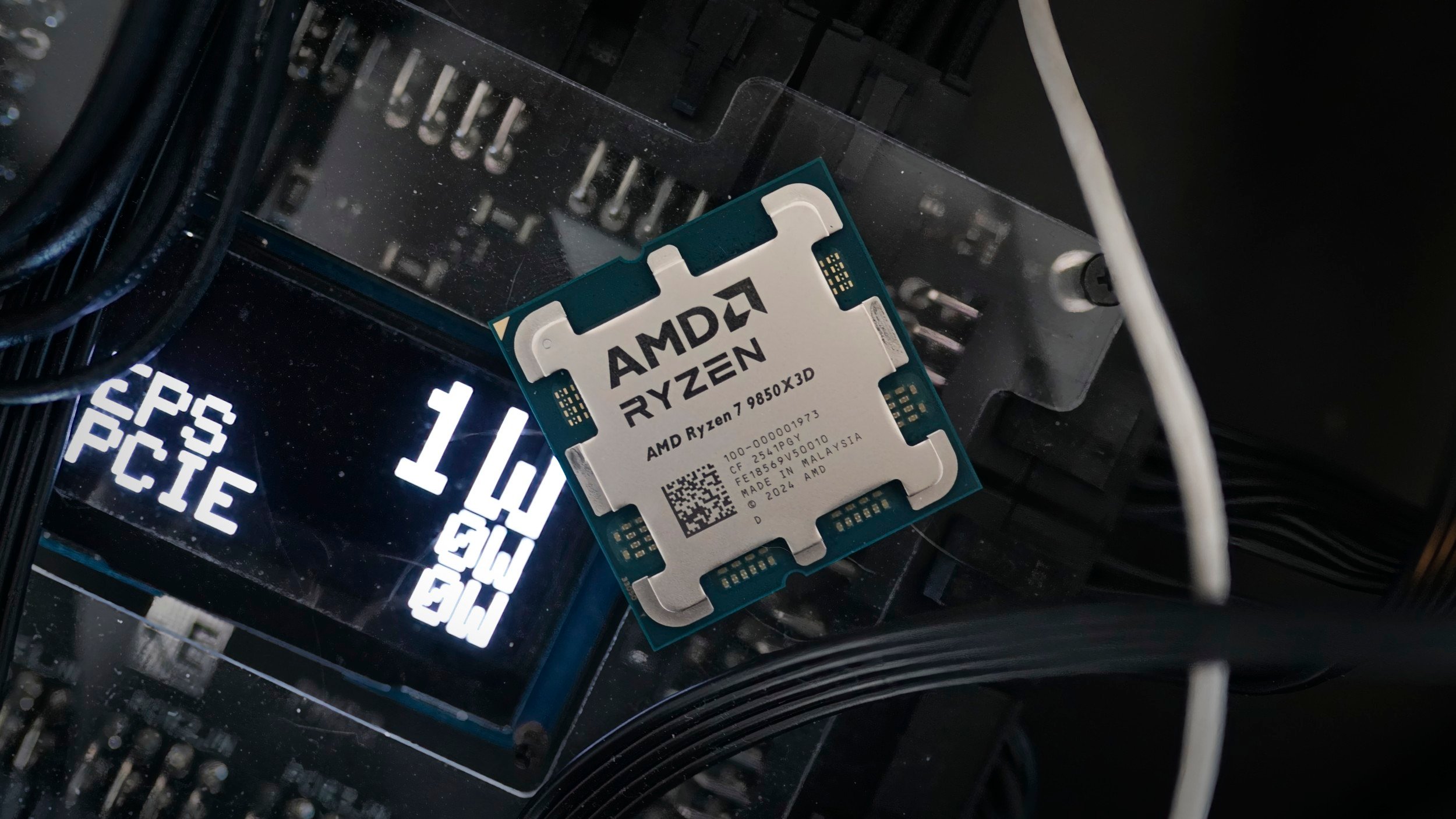 The AMD Ryzen 7 9850X3D CPU sitting on the PMD2 power tester.