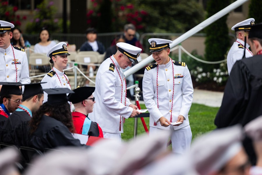 Five marine graduates smile during graduation ceremony.