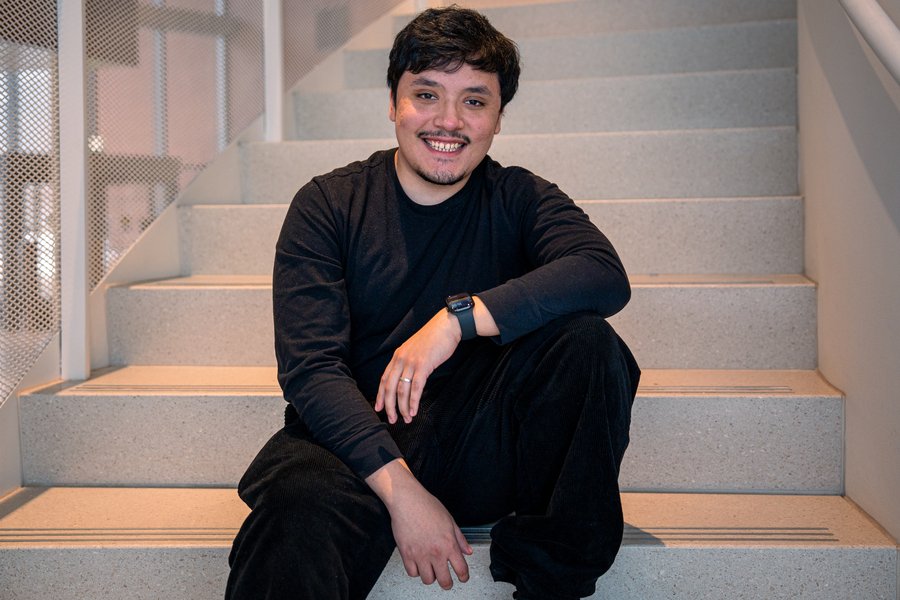 Carlos Mariano Salcedo poses seated on a staircase