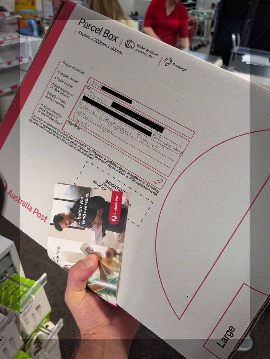 The packaged MacBook on the Australia Post counter, wrapped and ready to send