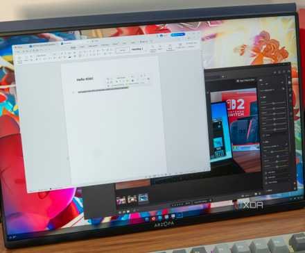 A monitor displaying an AnduinOS desktop with Windows apps running through WinApps