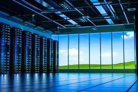 A data center overlooking a green, sunny landscape
