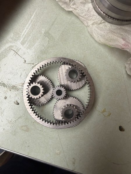 Gearset with a central gear that drives three adjacent gears that propel a surrounding ring