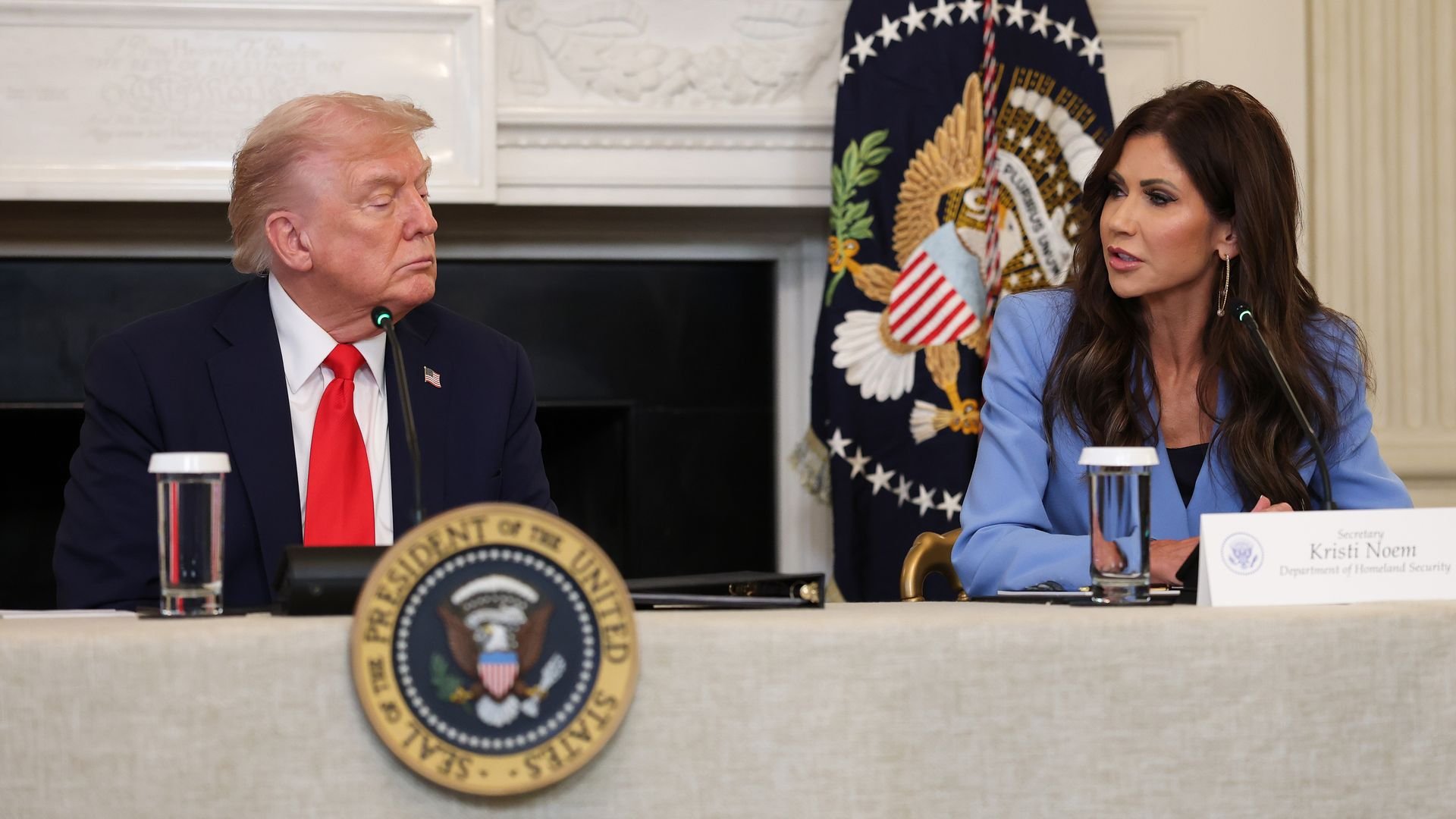President Trump and Homeland Security Secretary Kristi Noem attend a meeting in the White House State Dining Room last year. 
