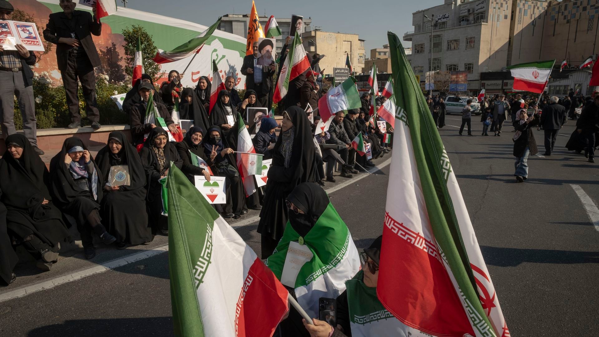 Iranian protesters carry country flags and participate in a pro-Government rally in Tehran, Iran, on January 12, 2026. The rally takes place in Tehran against the recent anti-government unrest, opposition to the U.S. and Israel in Iran, and in support of Supreme Leader Ayatollah Ali Khamenei. 