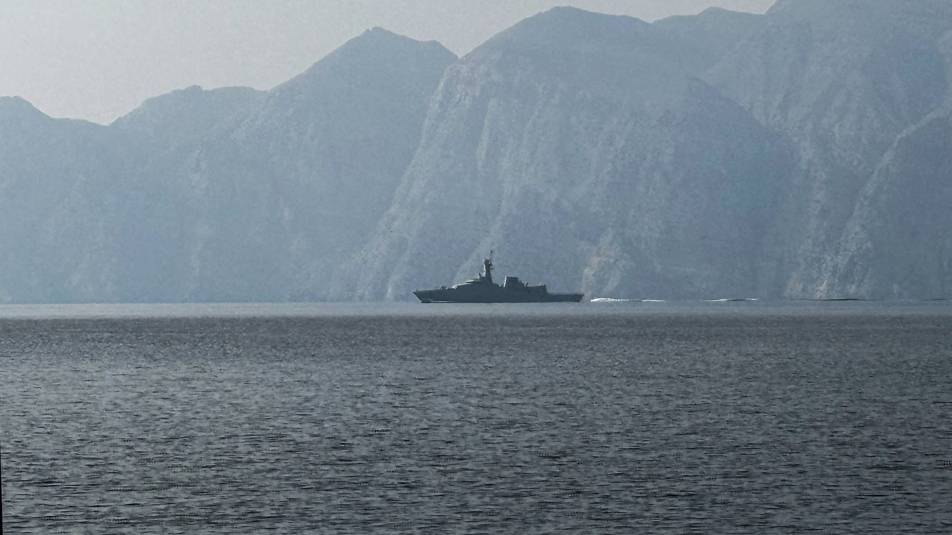 ship in water with mountains