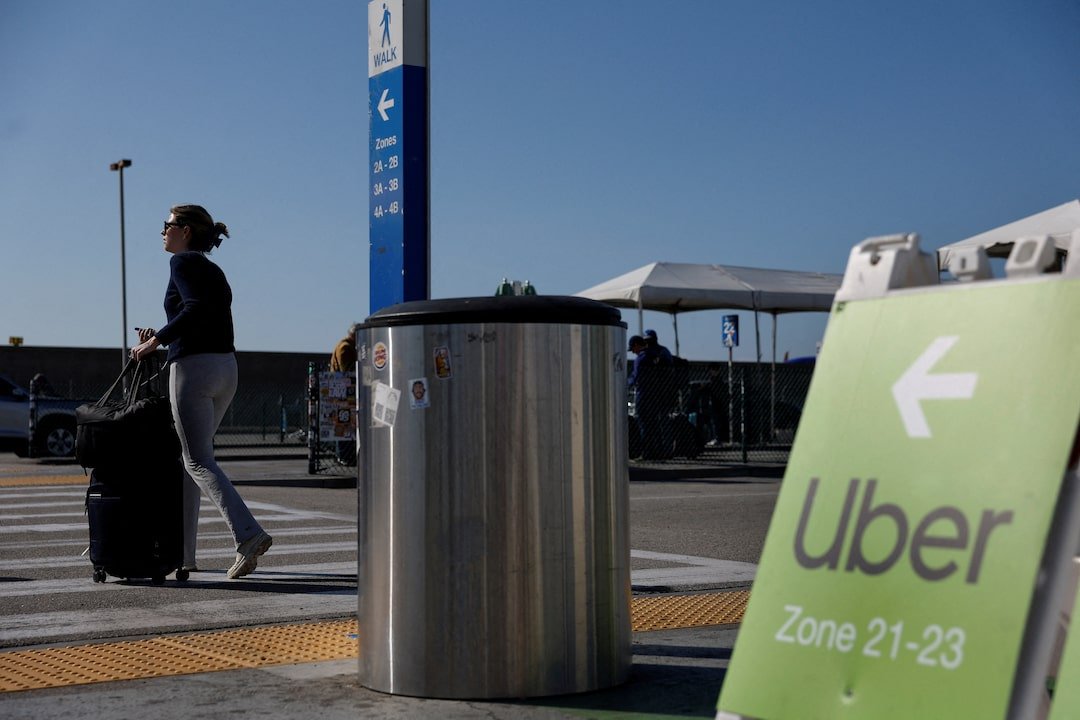 A traveler walks into the Uber pickup zone at the Los Angeles International Airport's LAX-it pick up terminal in Los Angeles