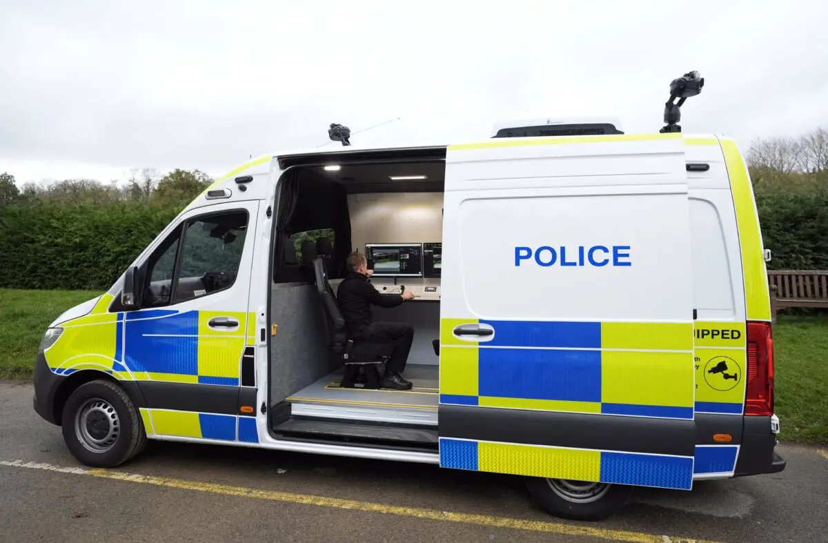 An undated image of a police officer viewing a camera feed from inside a live facial recognition vehicle at an undisclosed location in the UK. (Andrew Matthews/PA)