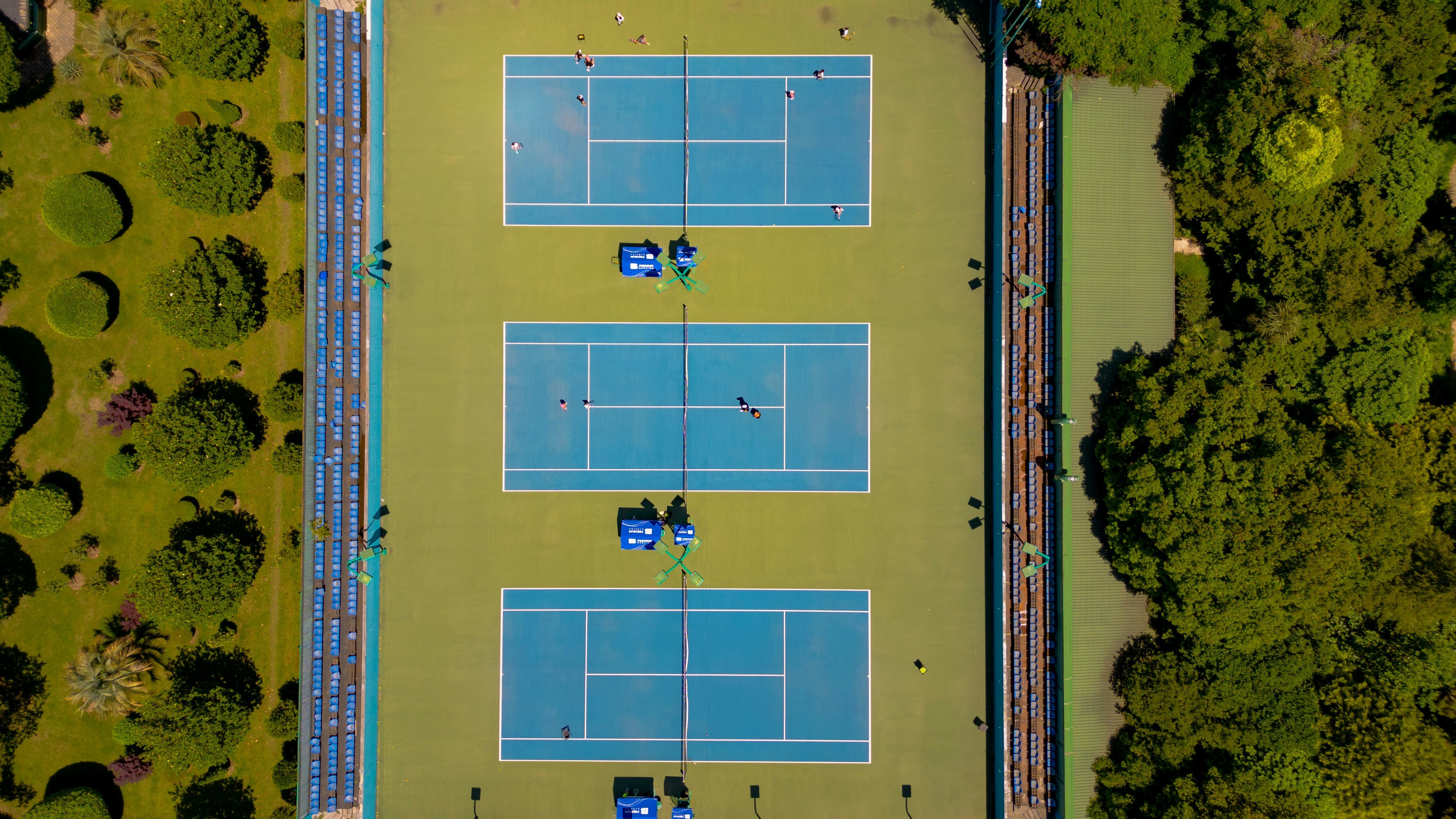 aerial view of three empty tennis courts