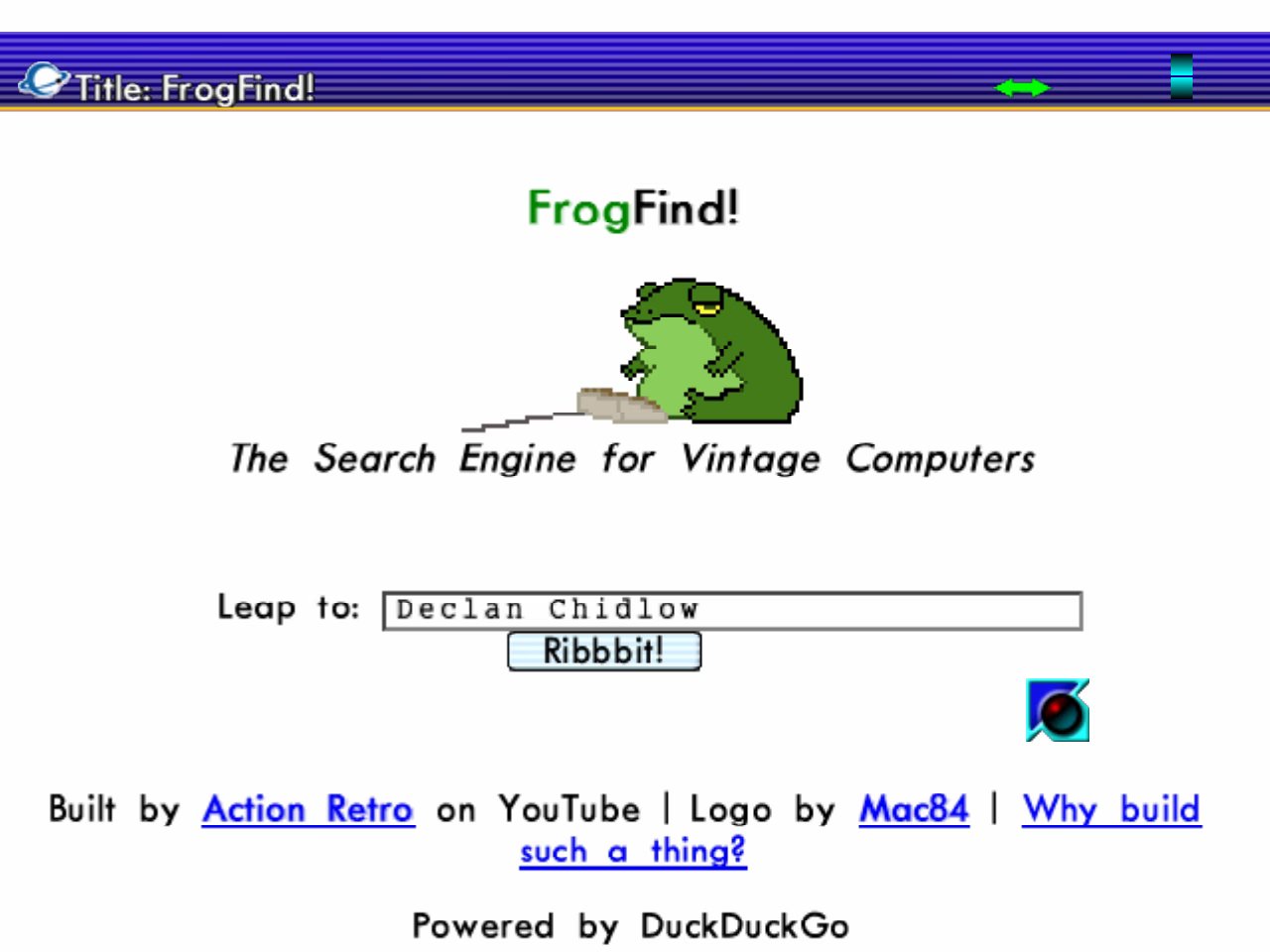 A white webpage reading 'FrogFind! The Search Engine for Vintage Computers' with a picture of a green frog with a computer mouse. At the top of the page is the browser interface, which is striped shades of blue and shows the PlanetWeb logo beside the current page title. The cursor is blue and glossy.