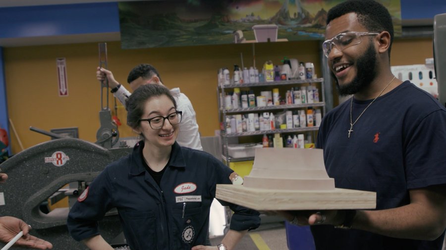 Two students examine a casting mold pattern