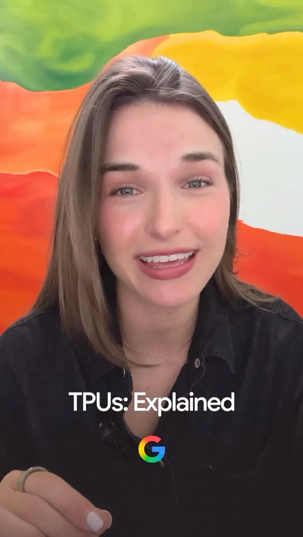 A woman with a mic talking to the camera in front of a colorful background. A text overlay says TPUs: Explained