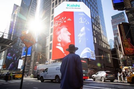 A large electronic billboard shows the odds of a Trump presidential win, 99-1 against Kamala Harris