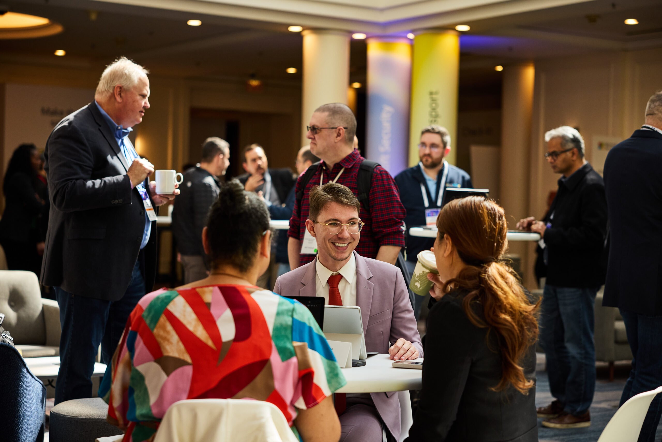 People talking around tables at a conference.